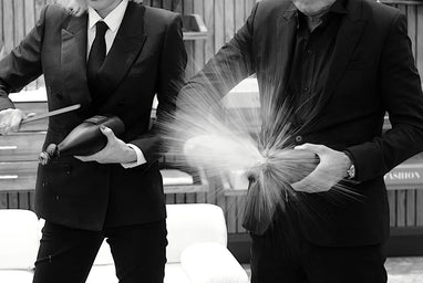 Sabering a personalized COUP champagne bottle as part of an executive gift experience and celebratory moment