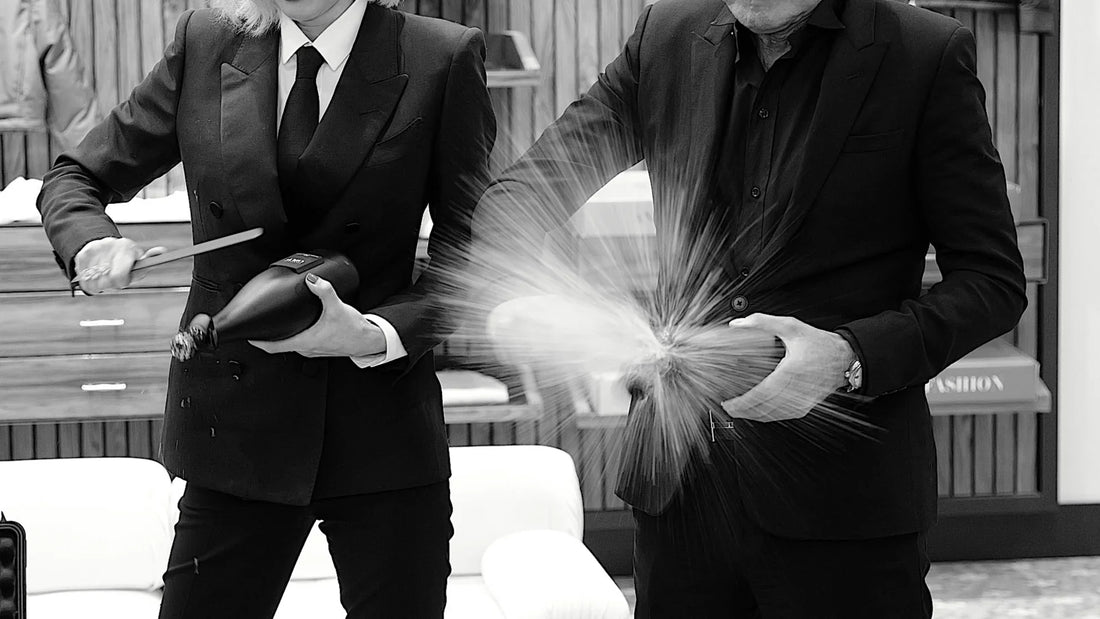 Sabering a personalized COUP champagne bottle as part of an executive gift experience and celebratory moment