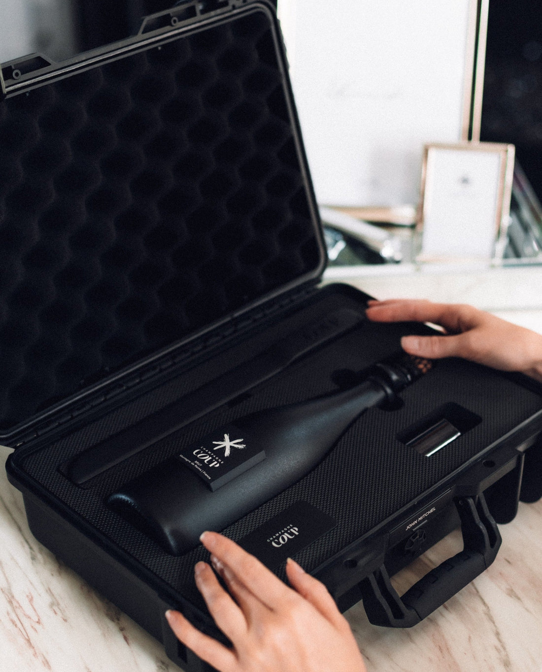 COUP hard-sided champagne case shown up close for a premium corporate gift presentation.